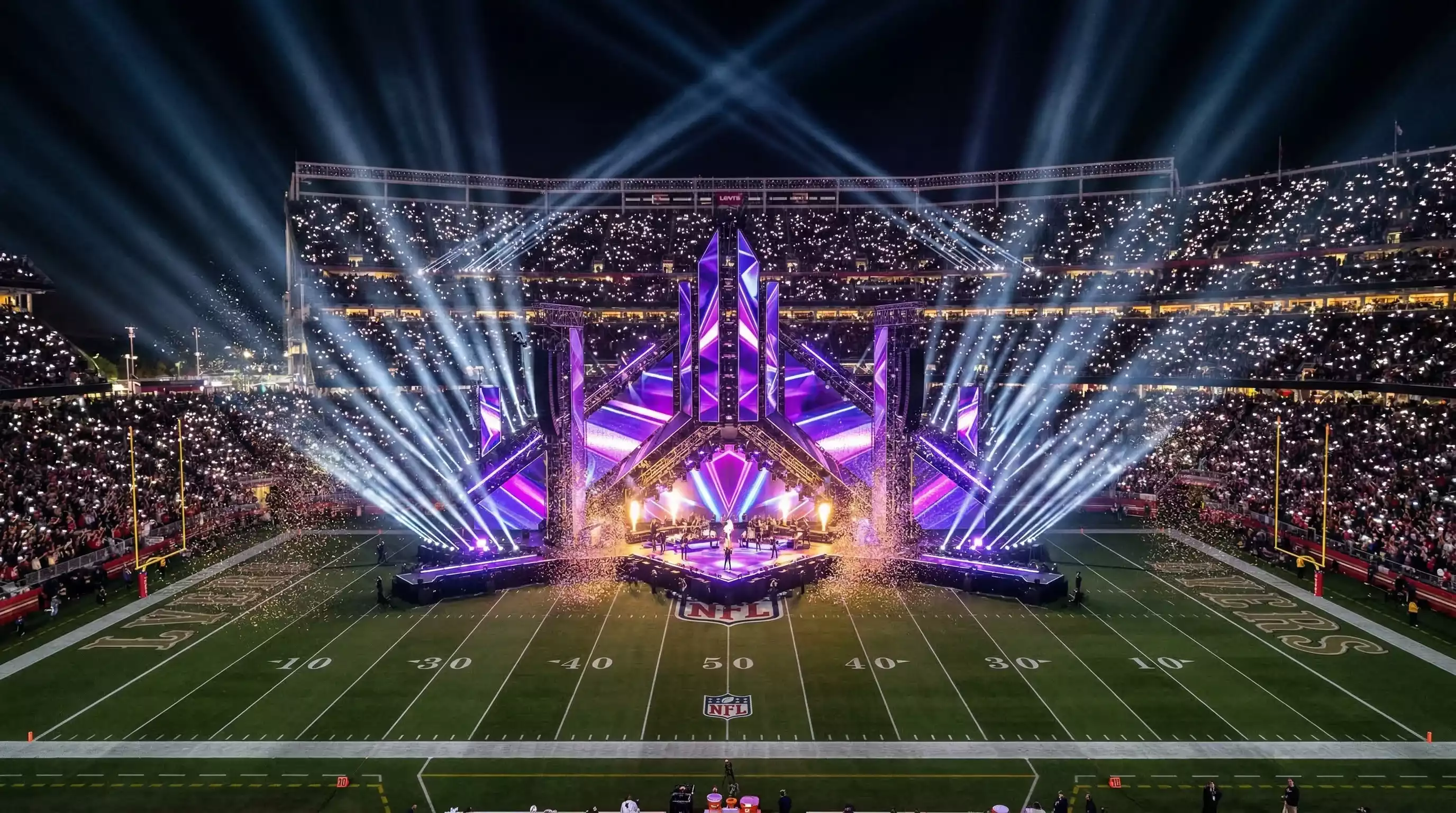 Escenario del halftime show del Super Bowl con luces y efectos especiales ante miles de espectadores
